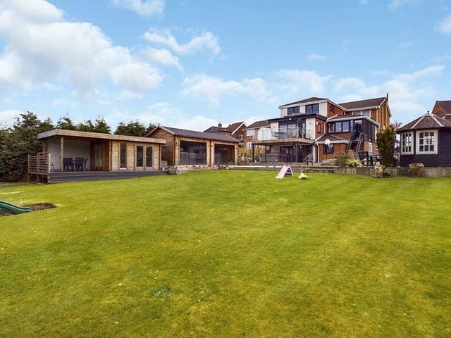 This shot, taken from the back garden, shows the summer house, spa and balcony at the property.