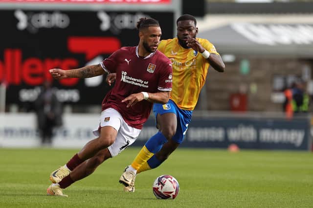 Deji Oshilaja shadows Northampton's Tyler Roberts last season.