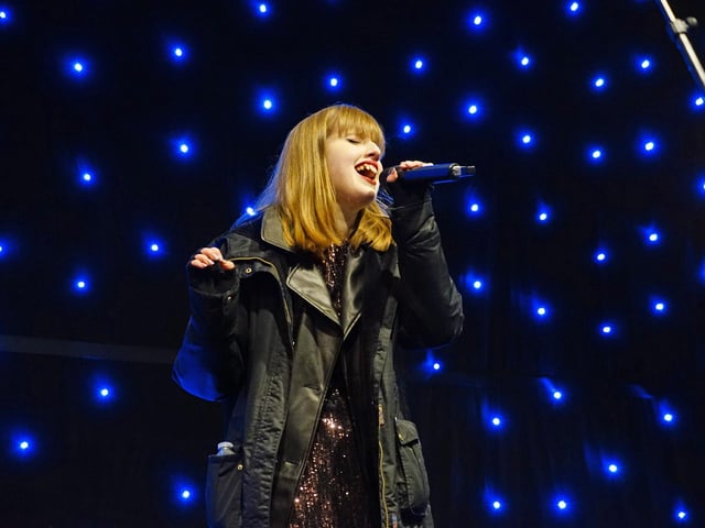Singer Breanna performing on stage at the event.