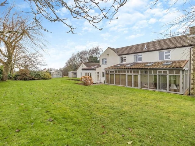 The south facing rear garden has raised lawns and a substantial sandstone patio and retaining stone wall boundary which extends the full width of the property.