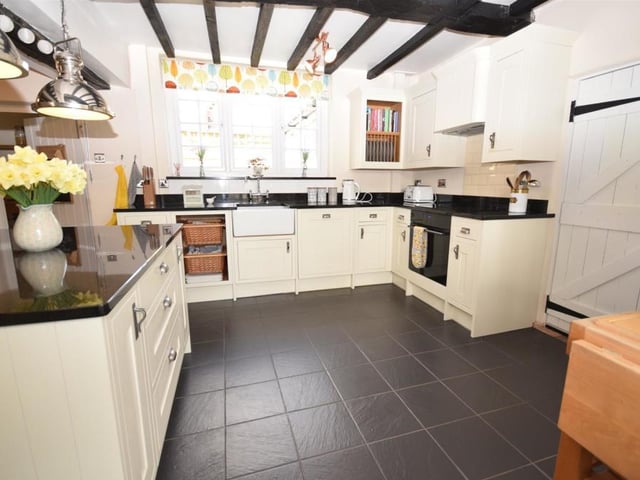 The dining kitchen is a fine example of how Maid Marian's Cottage mixes old and new. On the one hand, there is the beamed ceiling. On the other, integrated appliances, including an oven, four-ring ceramic hob and dishwasher, plus elegant wall cupboards, base units, drawers and stylish granite worktops.