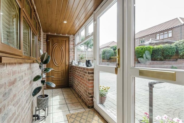 Step inside the £480,000 property via this entrance porch, which has a tiled floor and ceiling spotlights, and leads to the hallway.