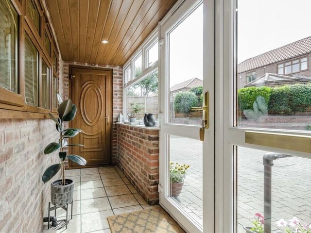 Step inside the £480,000 property via this entrance porch, which has a tiled floor and ceiling spotlights, and leads to the hallway.