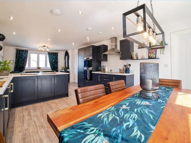 The open plan kitchen features space for a dining room table and lounge area.