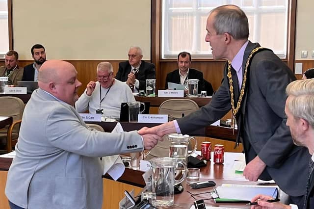 Coun Nigel Moxon hands in the petition to Coun Richard Butler, Nottinghamshire Council chair. Photo: Submitted