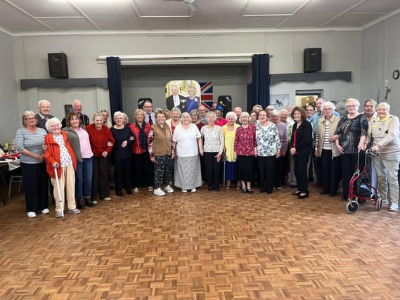A group photo of coronation celebrations underway.