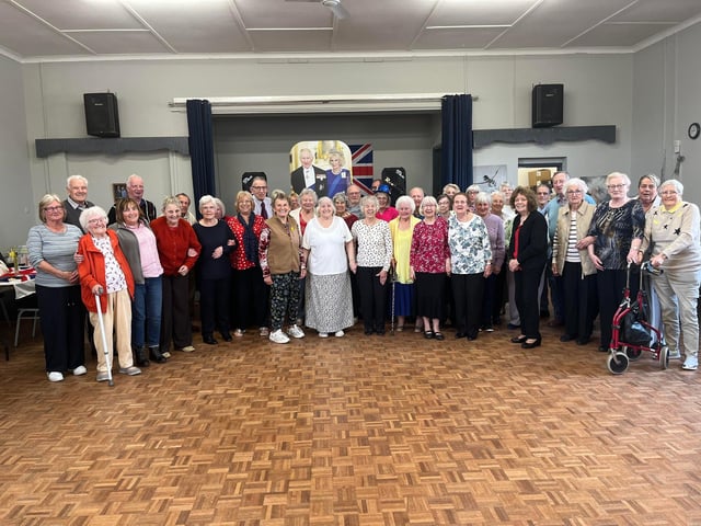 A group photo of coronation celebrations underway.