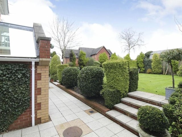 This last photo in our gallery gives a snapshot of the back garden, with its lawn, patio, shrubs and hedges.