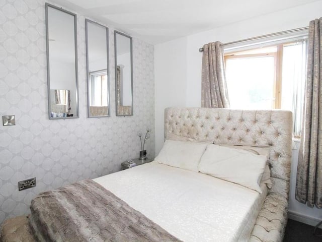 The first bedroom from a different angle. It is bright and light.