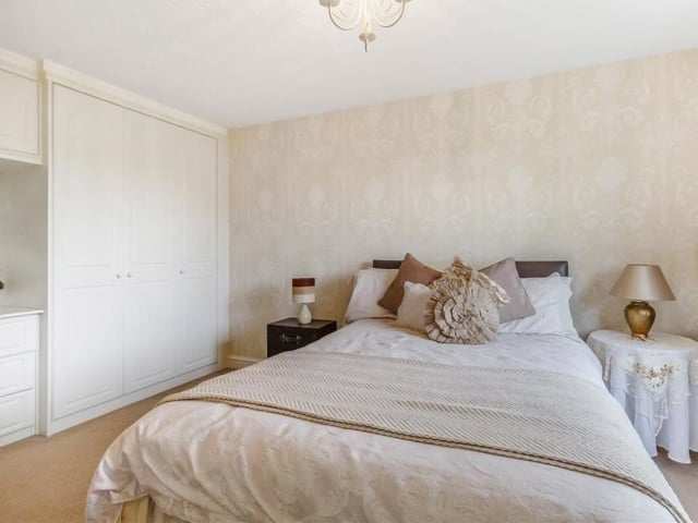 Like the master, the second bedroom is also fitted with wonderful wardrobes, complete with hanging rails, shelves, overhead cupboards and a dressing table.