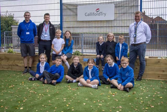 Back row 2nd left is Thomas Ellis (Ops Mgr/ Galliford Try) with staff and children at Mapplewells