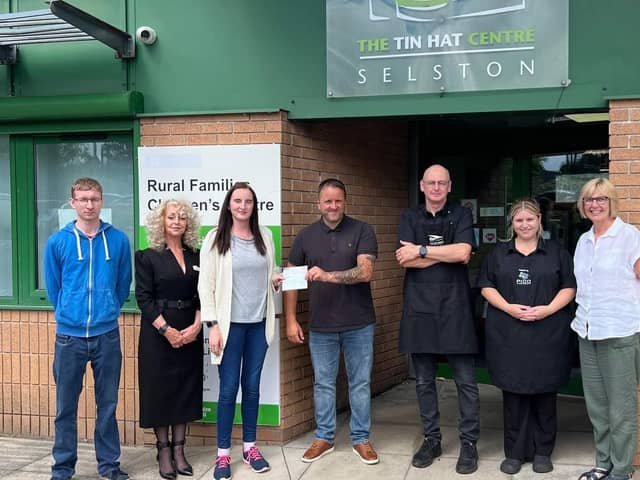 Michael's family members and friends presented a cheque for £360 to the Tin Hat Community Cafe.