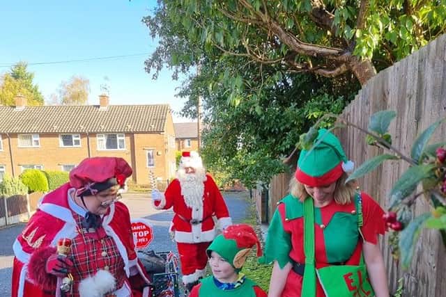 Billy Dawes aged six and his mum Eve Dawes, 41, dressed as Christmas elves in a sponsored walk at Pleasley. Along the way, they had a surprise encounter with Santa and Mrs Claus.