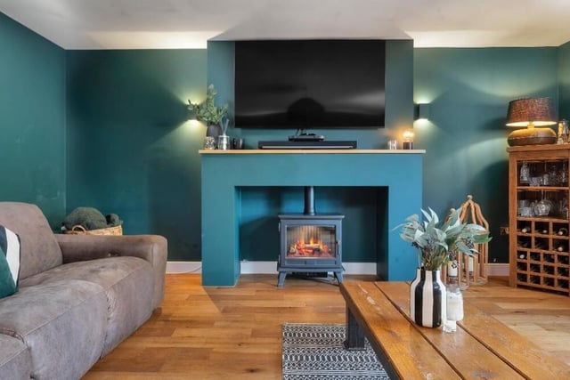 A focal point of the lounge is this charming feature fireplace with inset electric log-burner.