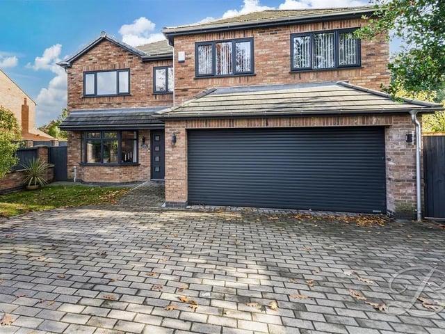 The property boasts an impressive double garage and a driveway.