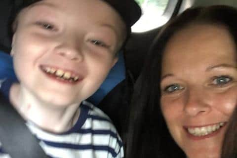 A smiling Zach with his mum, Tricy.