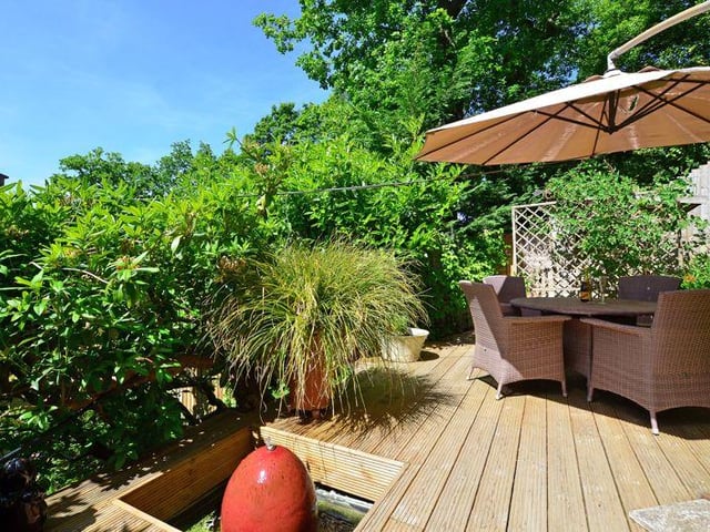 There is a terrace with a water feature.