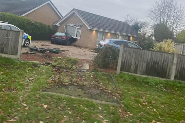 The devastation where the car ploughed through the fence and into the bungalow can be seen - a bench stood on the square in front of the fence.