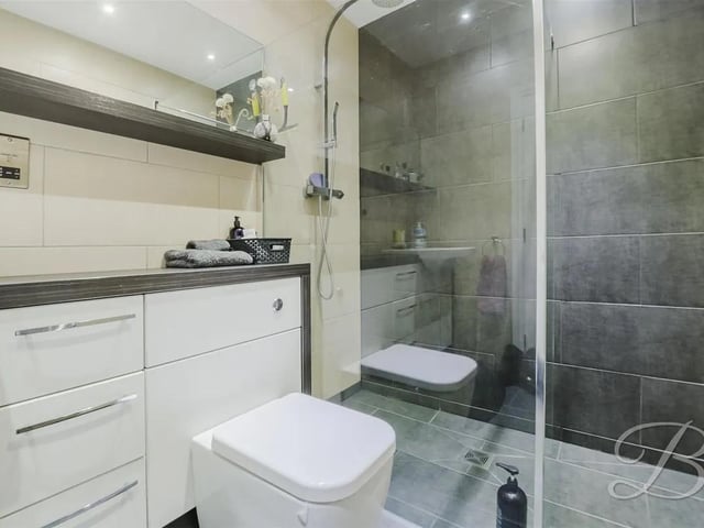 The stylish ensuite features a three piece suite comprising of a hand wash basin, low flush WC and shower.