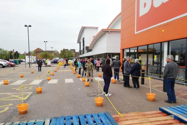 People social distancing outside of the Sutton B&Q store trial opening