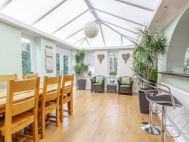 The dining room is also part of the orangery, while French doors lead outside to the garden.