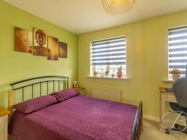 The second bedroom, which is at the front of the end-terrace Mansfield house, offers colour and style. An abundance of light flows through the two windows.