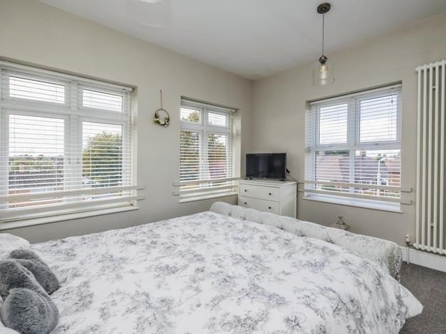 The four double bedrooms can all be found upstairs, beginning with this, number one, which is bonny and bright thanks to three windows.