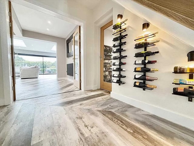 The stunning and spacious entrance boasts a unique wine cellar wall feature.