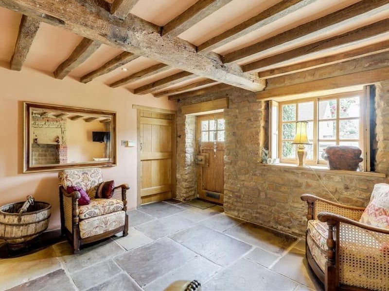 Straight through the front door and into this welcoming sitting room, where we start our tour of the £550,000 Linby cottage. The room typifies the character and charm of the property, with features such as flagstone flooring, an exposed brick wall and a window with a solid-oak frame and shutters.