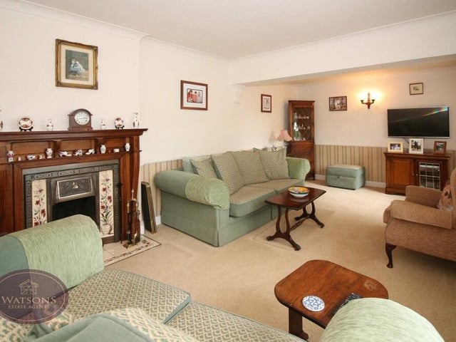 The first room to look at inside the Kimberley bungalow is this generously-sized lounge, which features an original open fireplace.