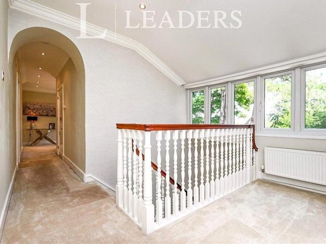 Time now to move up to the first floor, via a traditional, dog-leg balustraded staircase, to this landing, where there are two storage cupboards and access to the loft.