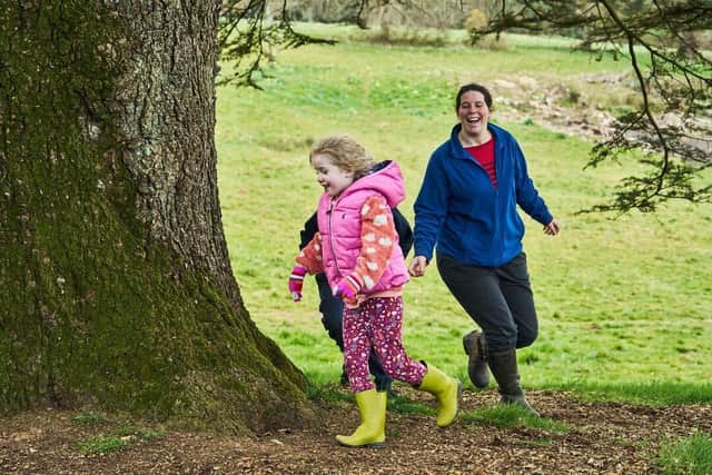 Family dancing around a tree