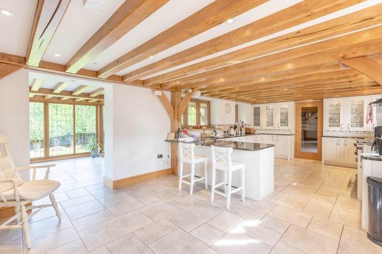 Let's begin our tour of the £1 million property in the large open-plan kitchen, which has living space too. It is fitted with an extensive range of bespoke wall and base units and granite work surfaces, and boasts high-quality integrated appliances. A useful utility room sits next door.