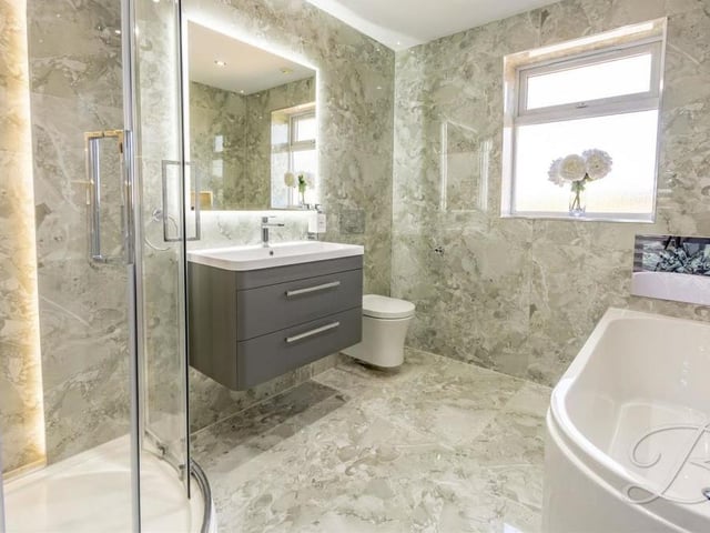 A second shot of the bathroom, which is the kind you might expect to find at a five-star hotel;. Floor-to-ceiling tiling, underfloor heating and a chrome, heated towel-rail add to its appeal.