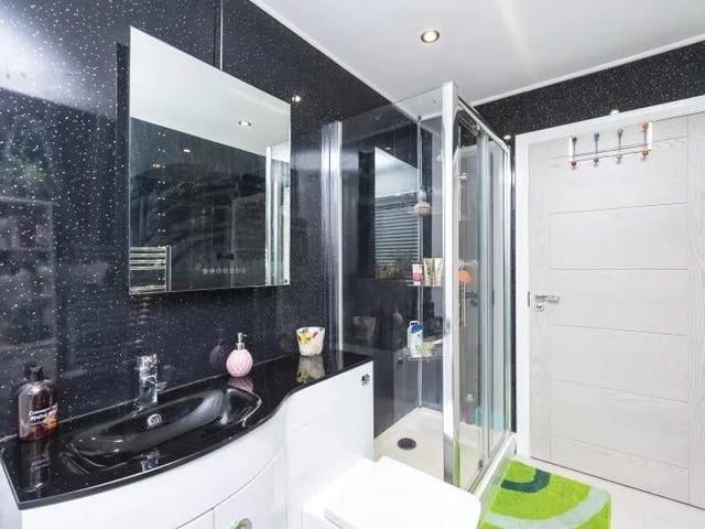 There are bathrooms on both floors of the property. This sparkling one on the ground floor is the largest, comprising a four-piece suite that includes double shower enclosure, panelled bath, wash basin and WC.