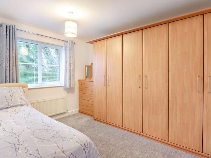 Bedroom number three also boasts plenty of wardrobe space, as these floor-to-ceiling giants testify. The window faces the back of the house,