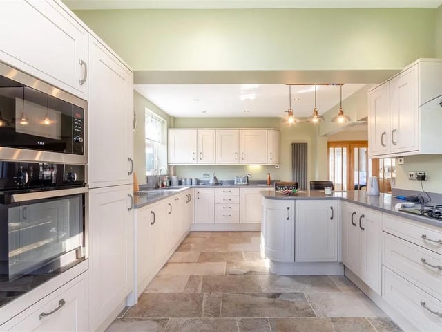 There is a peninsula island with space for stools and an integrated wine cooler beneath. Integrated dishwasher and integrated fridge/freezer. Tiled floor, ample ceiling spotlights, two contemporary vertical radiators, velux roof window to the rear elevation, double glazed window to the side elevation, double glazed windowpane to the rear elevation and French doors leading out onto the rear garden.