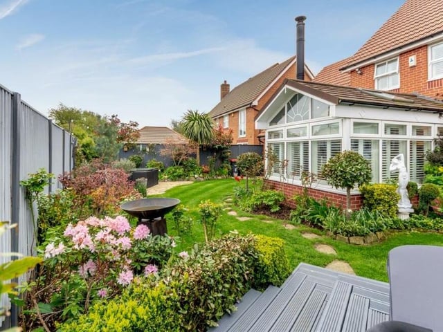 The gardens, at both the front and back of the house, are full of colour. The back also has a stone patio with water feature, power point and lighting.