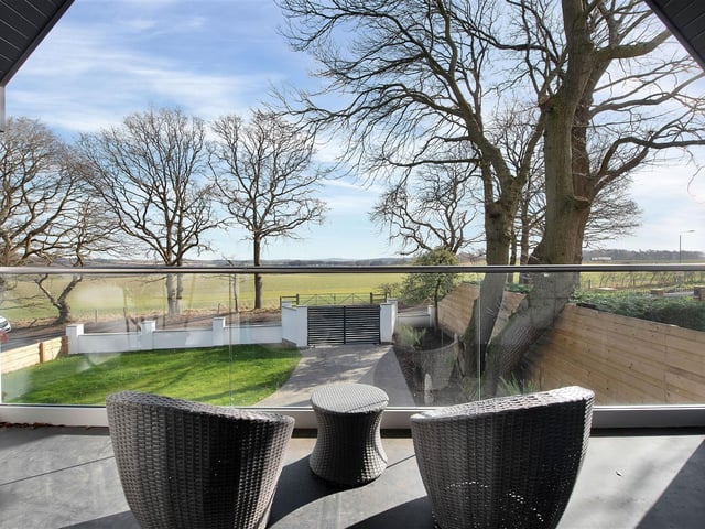 A fantastic outdoor seating area with high vaulted ceiling and wonderful open countryside views.