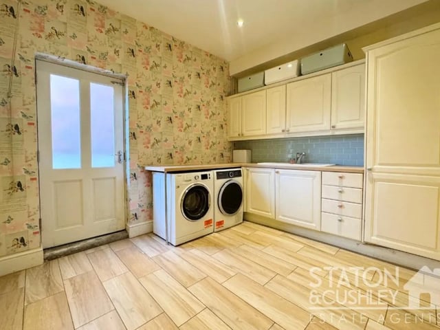 The laundry room offers additional space for your essential appliances such as washing machine and dryer.
