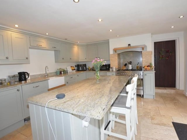 The kitchen has space for everything you need, including plumbing for an American-style fridge freezer. A range of units, granite worktops and a grooved drainer to an under-mounted Belfast sink add to the room's appeal. Double-glazed doors lead to the front garden.