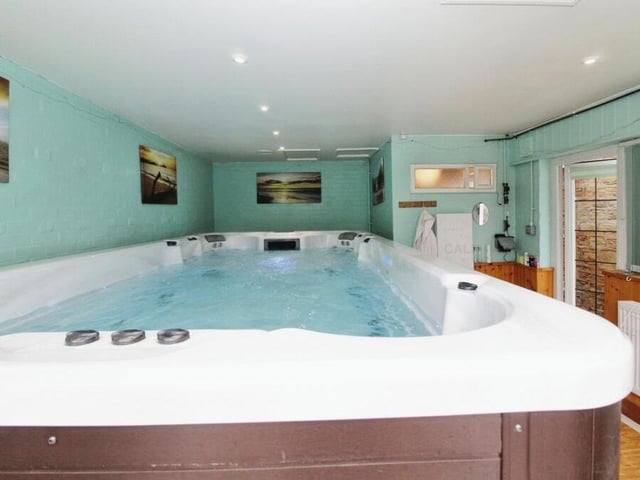 Adjoining the conservatory is this luxurious Riptide Neptune swim spa, with a pool for exercising and six seating areas. Next to it is a convenient toilet, accessible from the garden.