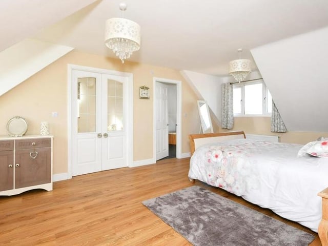 A second shot of the main bedroom, showing access to en suite facilities and also a walk-in wardrobe.