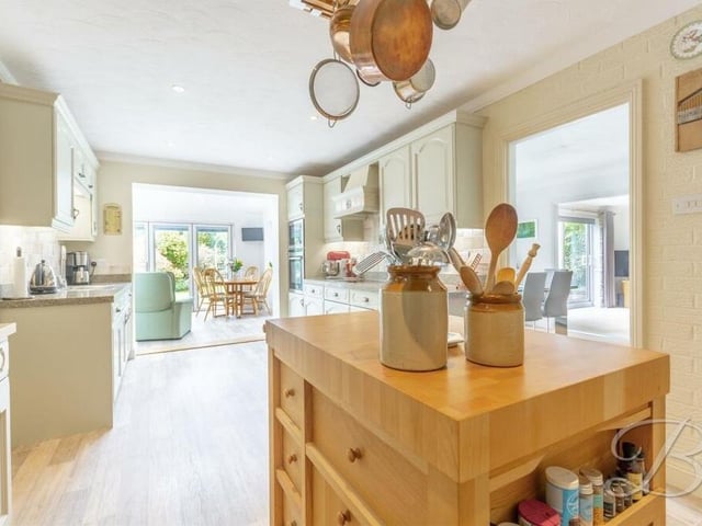 The sizeable kitchen from a different angle. There is more than enough space for appliances, while downlights add to its brightness. It has access to a utility room and WC, and it opens effortlessly into the breakfast or garden room.