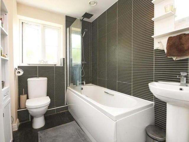 It's time to move upstairs now at the Topaz Crescent property, and the first port of call is this stylish family bathroom. It includes bath, low-flush WC and wash hand basin, not to mention very sleek decor.