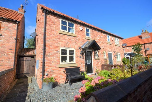 This two bedroom cottage has a conservatory with rustic oak laminate flooring and "very pleasant" views of the rear garden and garden room.