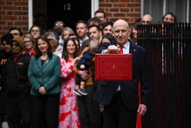 Chancellor of the Exchequer John Healey  holds up the traditional red ministerial box as he leaves 11 Downing Street, London, before delivering his first Budget to the Houses of Parliament. Picture date: Wednesday October 28, 2026. PA Photo. Photo credit should read: Dylan Martinez/Press Association