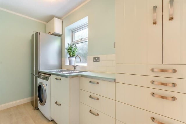 Just off the kitchen is this handy utility room, which has space and plumbing for a washing machine and space for a fridge freezer. It is fitted with wall cupboards, drawers and a stainless steel sink with drainer and mixer tap.