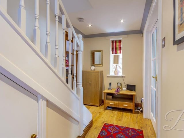 As we prepare to go upstairs, here is the entrance hallway. Compact but cute.
