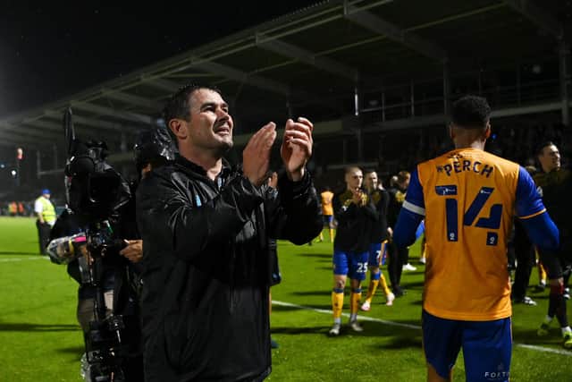 Stags boss Nigel Clough celebrates with the fans after their side's victory at Northampton Town in last week's play-offs showdown.